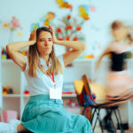 Why Your Classroom Gets Louder: Early Childhood Classroom Management Strategies for Instant Calm 1 Stressed teacher in chaotic classroom.